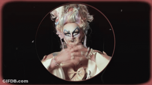 A Woman With Long Nails And Pearls On Her Wrists Is In A Circle GIF
