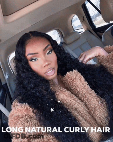 A Woman With Long Natural Curly Hair Is In The Back Seat Of A Car GIF