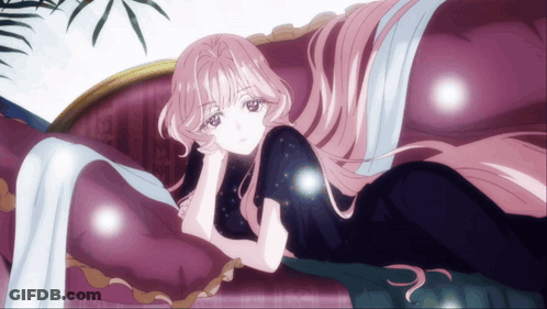 A Woman With Long Pink Hair Is Laying On A Couch GIF