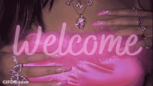 A Woman With Long Pink Nails Is Wearing A Necklace And Rings And The Words Welcome Are Displayed GIF