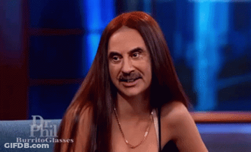 A Woman With Long Red Hair And A Mustache Is On A Show Called Phil Burrito Glasses GIF