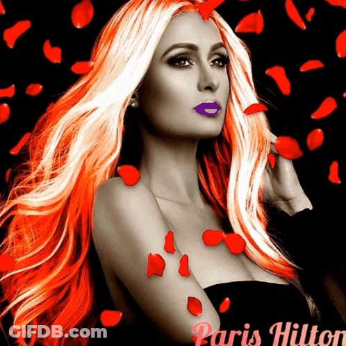 A Woman With Long Red Hair And Purple Lips Is Surrounded By Red Rose Petals And The Name Paris Hilton GIF