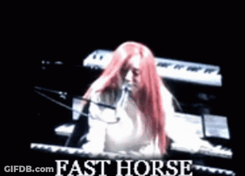 Woman With Red Hair Playing Piano And Singing Fast Horse GIF