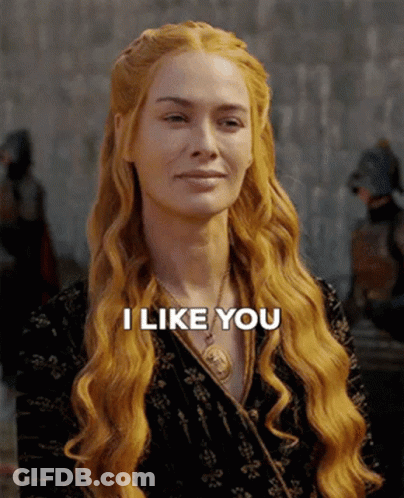 A Woman With Long Red Hair Is Smiling And Says " I Like You " GIF