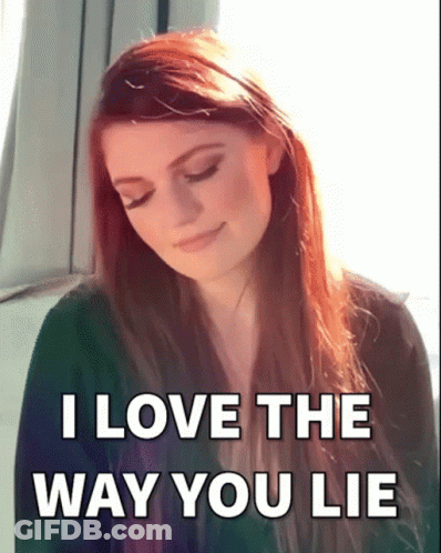 A Woman With Long Red Hair Is Smiling With The Words I Love The Way You Lie Below Her GIF