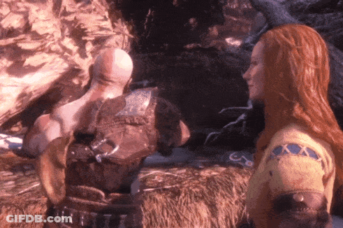 A Woman With Long Red Hair Is Standing Next To A Man GIF