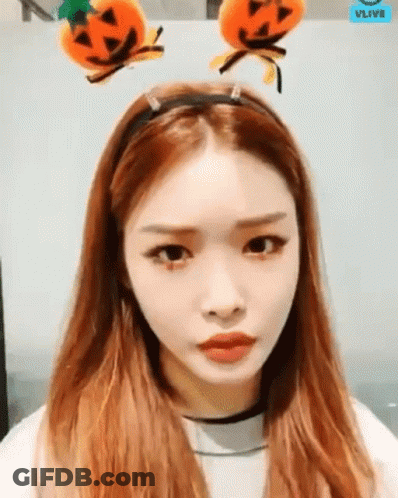 A Woman With Long Red Hair Wearing A Headband With Pumpkins On It . GIF