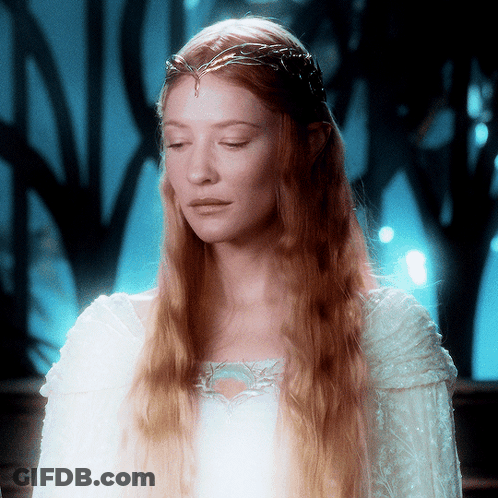 A Woman With Long Red Hair Wearing A White Dress GIF