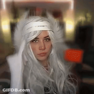 A Woman With Long White Hair And A White Hat GIF