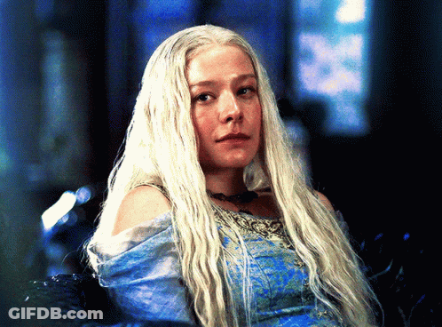 A Woman With Long White Hair Is Wearing A Blue Top GIF