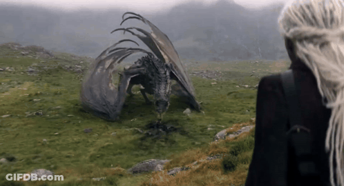 A Woman With Long White Hair Stands In Front Of A Dragon GIF