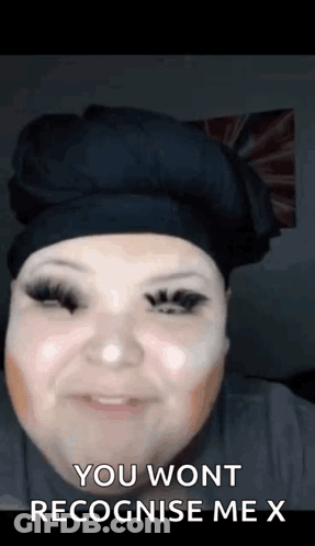 A Woman With Makeup On Her Face Is Smiling And Says `` You Won T Recognise Me X '' . GIF