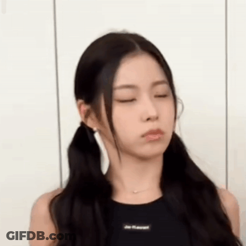 A Woman With Pigtails Is Making A Funny Face . GIF
