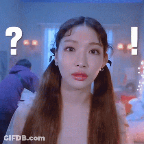 A Woman With Pigtails Is Making A Funny Face With A Question Mark In The Background . GIF