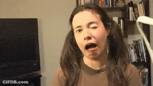 A Woman With Pigtails Making A Funny Face In Front Of A Tv GIF
