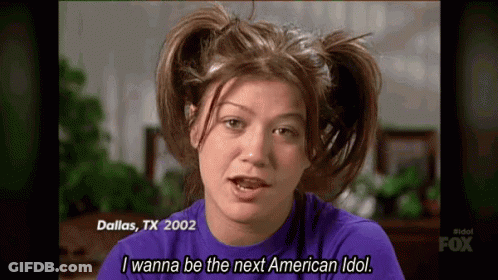 A Woman With Pigtails On Her Head Is Wearing A Purple Shirt And Says I Wanna Be The Next American Idol . GIF