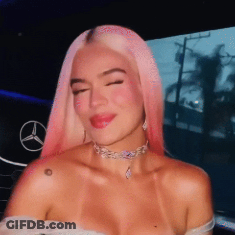 A Woman With Pink Hair And A Choker Is Smiling GIF