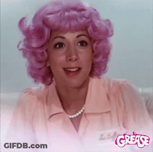 A Woman With Pink Hair And A Name Tag That Says ' Grease ' GIF