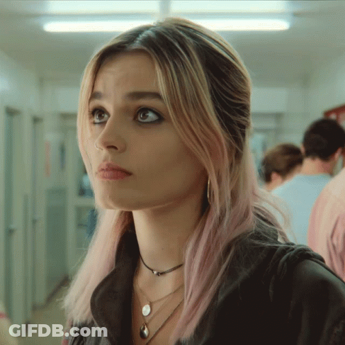 A Woman With Pink Hair And A Nose Ring GIF
