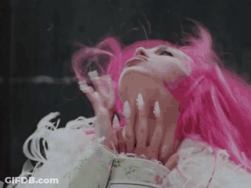 A Woman With Pink Hair And White Nails GIF