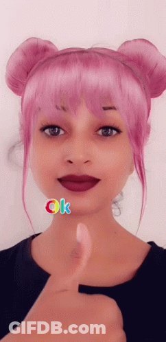 A Woman With Pink Hair Gives A Thumbs Up GIF