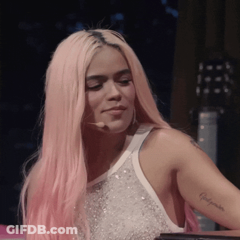 A Woman With Pink Hair Has A Tattoo On Her Arm That Says ' Felicidades ' GIF