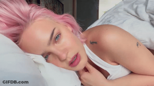 A Woman With Pink Hair Has A Tattoo On Her Shoulder That Says ' Hope ' GIF