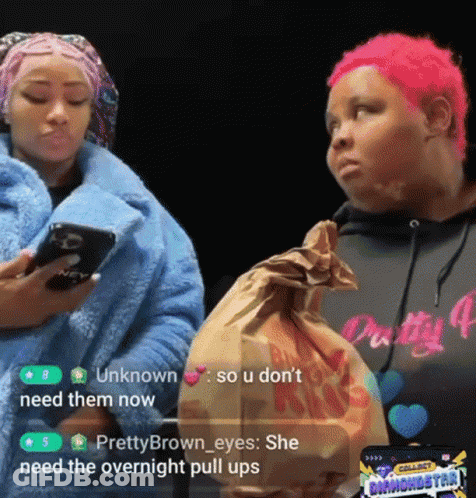 A Woman With Pink Hair Is Holding A Bag Of Food While Another Woman Looks On GIF