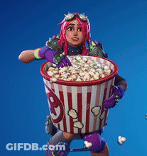 A Woman With Pink Hair Is Holding A Bucket Of Popcorn . GIF