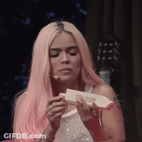 A Woman With Pink Hair Is Holding A Piece Of Paper That Says ' Esperanza En La Libertad Original ' On It GIF