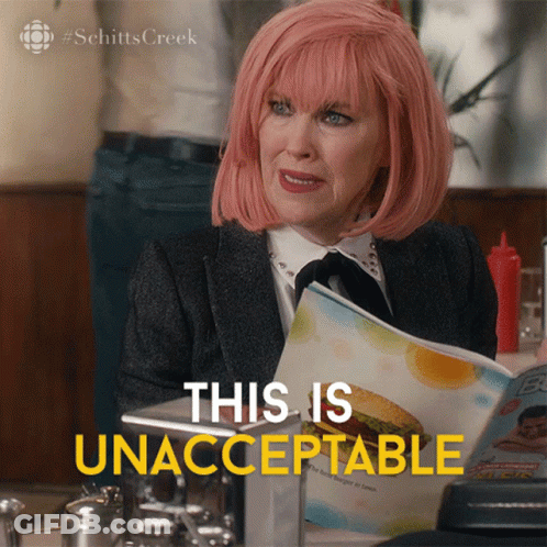 A Woman With Pink Hair Is Reading A Menu And Says This Is Unacceptable In Yellow Letters GIF