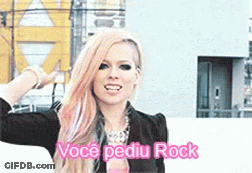 A Woman With Pink Hair Is Standing In Front Of A Building And Says Voce Pediu Rock GIF