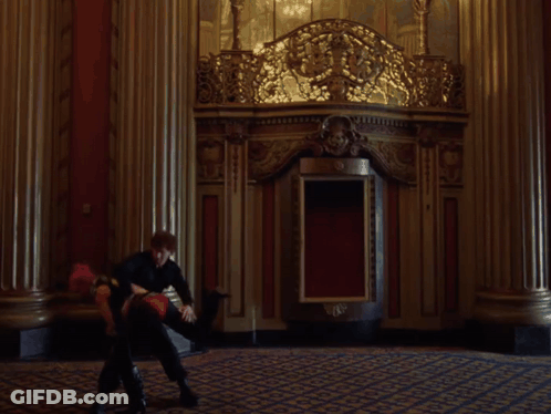 A Woman With Pink Hair Is Standing Next To A Man In A Black Top . GIF