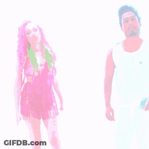 A Woman With Pink Hair Is Standing Next To A Man With White Pants GIF