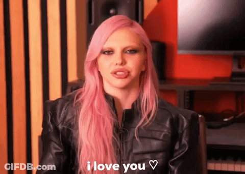 A Woman With Pink Hair Is Wearing A Black Leather Jacket And Says I Love You GIF