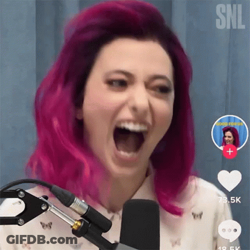 A Woman With Pink Hair Screaming Into A Microphone GIF