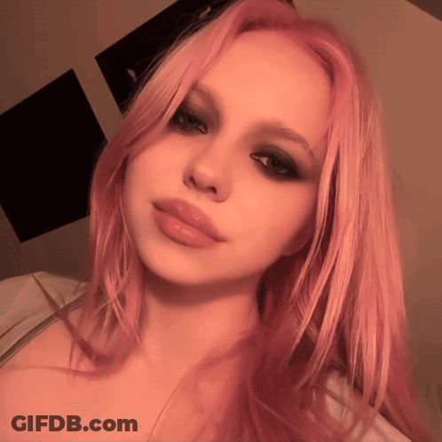 A Woman With Pink Hair Takes A Selfie With Her Eyes Closed GIF