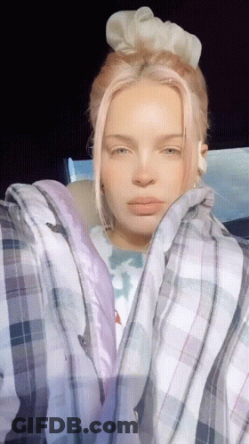 A Woman With Pink Hair Wearing A Plaid Shirt GIF