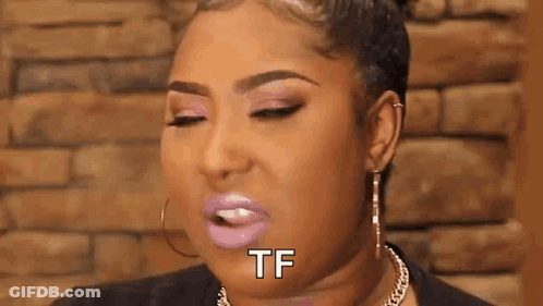 A Woman With Pink Lipstick And Earrings Is Making A Funny Face And Saying `` Tf '' . GIF