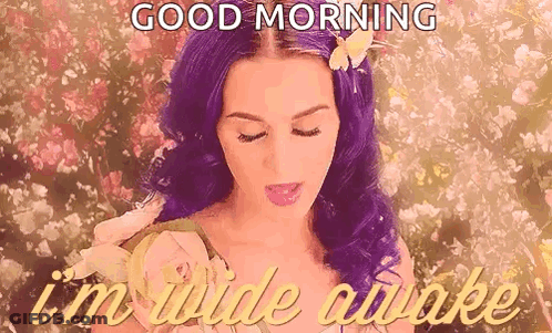 A Woman With Purple Hair And A Flower In Her Hair Is Saying `` Good Morning , I 'M Wide Awake '' . GIF