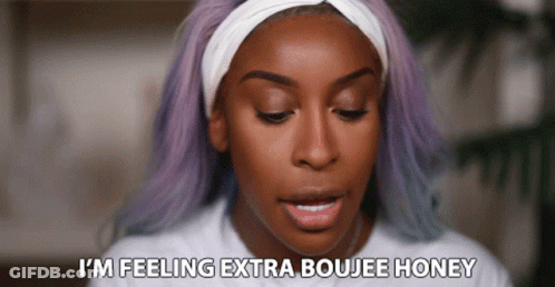 A Woman With Purple Hair And A Headband Says I 'M Feeling Extra Boujee Honey GIF