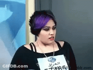 A Woman With Purple Hair Has A Name Tag That Says Arabic Gifs On It GIF