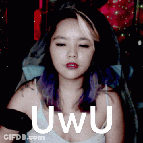 A Woman With Purple Hair Has The Word Uwu Written On Her Chest GIF