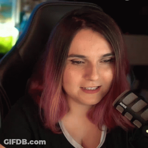 A Woman With Purple Hair Is Sitting In Front Of A Rode Microphone . GIF