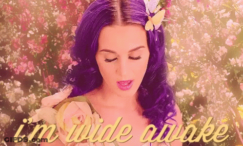 A Woman With Purple Hair Is Surrounded By Flowers And The Words " I 'M Wide Awake " Are On The Bottom GIF