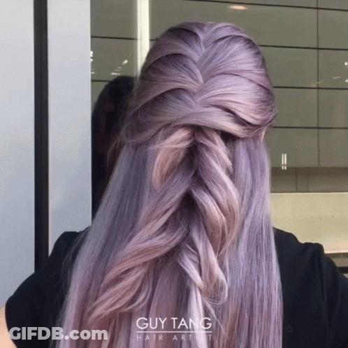 A Woman With Purple Hair Is Wearing A Braided Half Up Half Down Hairstyle From Guy Tang Hair Artist GIF