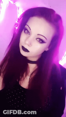 A Woman With Purple Hair Is Wearing A Choker And Black Lipstick GIF
