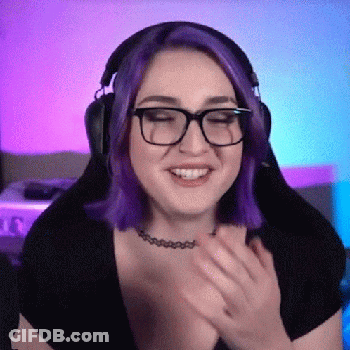 A Woman With Purple Hair Is Wearing Glasses And Headphones GIF
