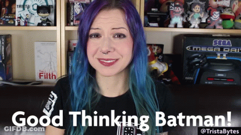 A Woman With Purple Hair Says Good Thinking Batman In Front Of A Sega Mega Drive GIF