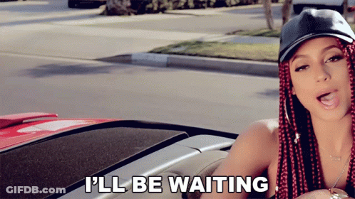 A Woman With Red Braids Is Sitting In A Car With The Words I 'Ll Be Waiting Above Her GIF